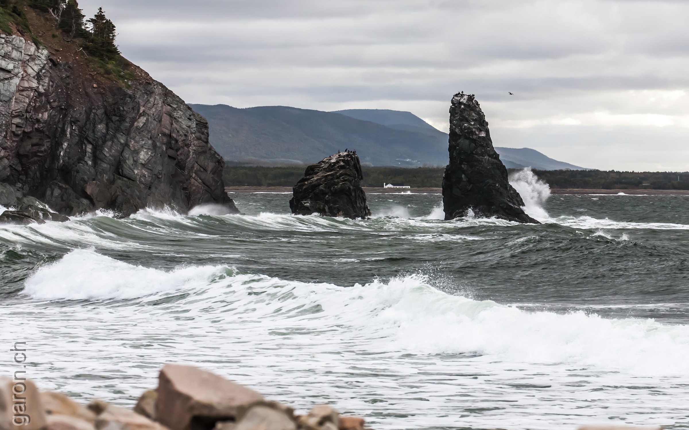 Along the Cabot Trail on Cape Breton Island, Nova Scotia Sea wawes splash on the rocky shore