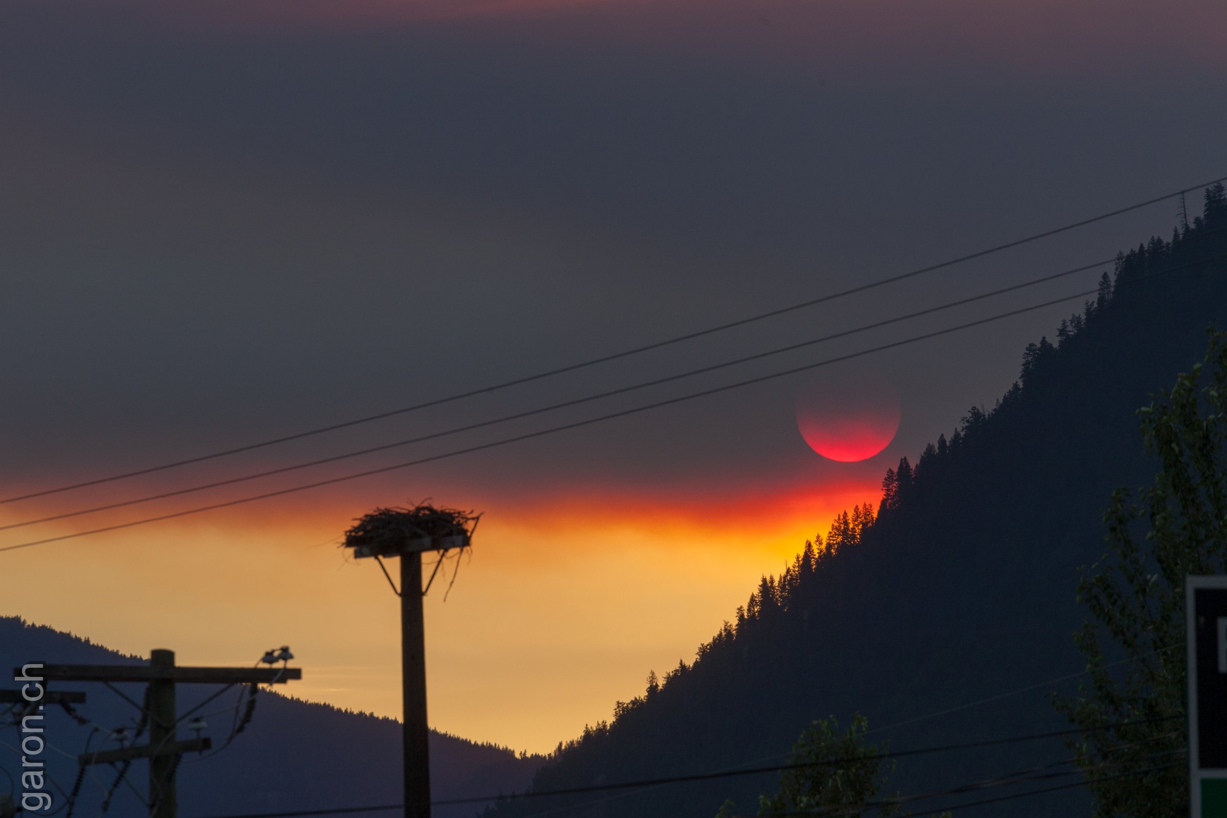 British Columbia, Salmon Arm Wildfire smoke covering sunset, near Canoe Beach